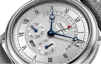 Silver wristwatch with detailed face showing date and day, brand 'FARST' visible.