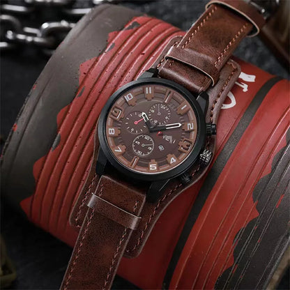 Brown leather watch with a detailed face on a red and black textured surface