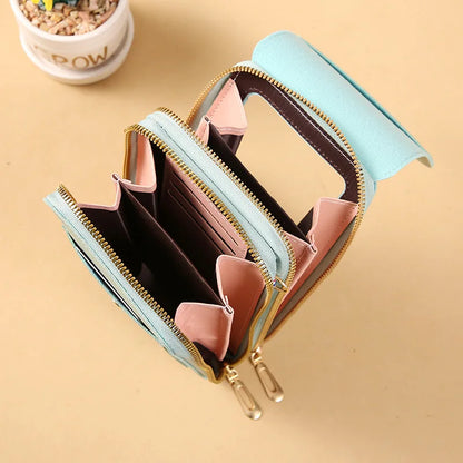 Open light blue wallet with pink interior on a beige background