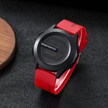Digital sports watch with a red strap on a dark surface