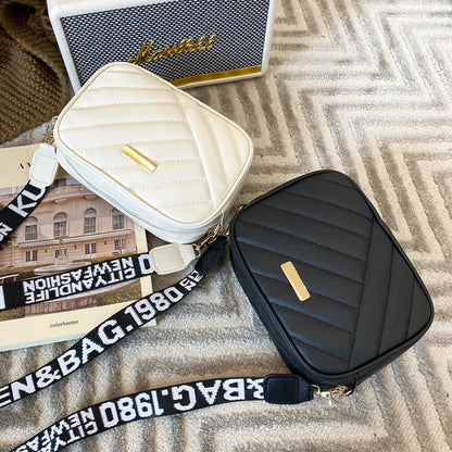 Two quilted crossbody bags, one white and one black, with a visible brand name on a textured surface.