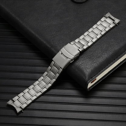 Silver watch strap on a black textured surface