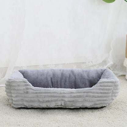 Gray pet bed with ribbed texture on a light background
