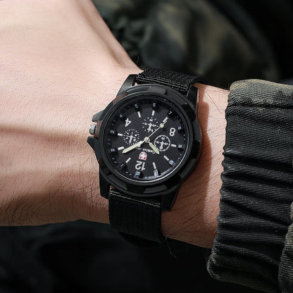 Black wristwatch on a person's wrist with a blurred background