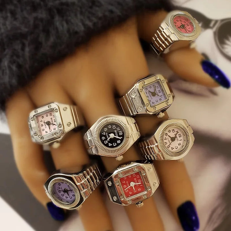 Multiple watch rings on a hand with a blurred background