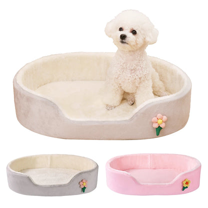 Dog sitting on a heart-shaped pet bed with flower designs in beige, gray, and pink colors.